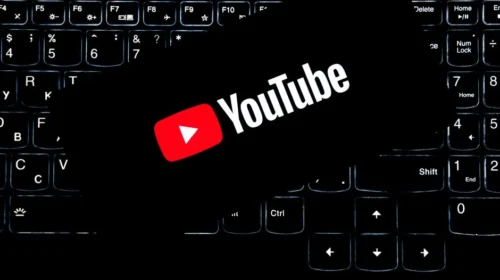 YouTube logo displayed on a backlit keyboard, representing digital media and online content creation.