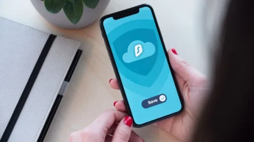 Woman using a secure mobile app, showcasing data encryption on a smartphone.